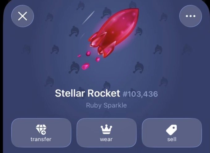 A digital collectible item display titled 'Stellar Rocket #103,436' in 'Ruby Sparkle' with options to transfer, wear, or sell.
