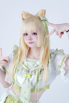 A person with long blonde hair styled in high pigtails with green ribbons poses in a matching mint green and white frilly outfit, making peace signs with both hands against a soft blue background, fitting the "mint green" themed POPA aesthetic referenced in the caption.
