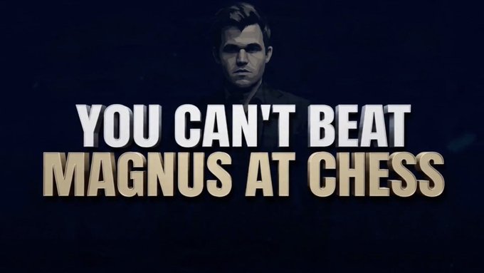 The image features a man with short hair wearing glasses standing against a dark background. He has a serious expression as he looks directly at the camera. Below him, there's text that reads "You Can't Beat Magnus At Chess", which seems to be a quote or a statement about chess. The text is in white and yellow colors, making it stand out against the dark background.