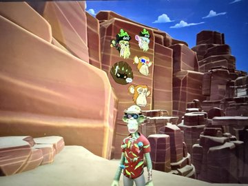 A screenshot from a video game showing a character with goggles and a red outfit standing in a desert-like canyon, with floating icons of meat and skulls above their head.