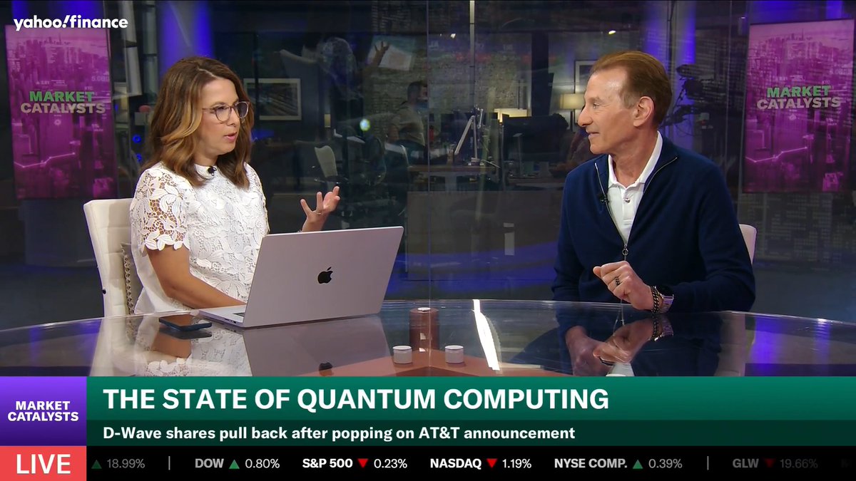 A Yahoo Finance "Market Catalysts" segment titled "The State of Quantum Computing" features two hosts discussing D-Wave shares, which are up 18.99% amid news of an AT&T announcement. The image ties to the post's argument that quantum computing threats to Bitcoin are overblown, as the same technology would simultaneously undermine far more critical global infrastructure like banking, SWIFT, and military communications.