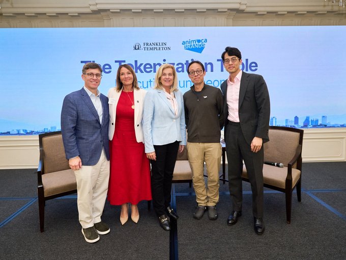 Jenny Johnson stands on stage at the Tokenization Table alongside Yat Siu, Brian Chan, and two other panelists, with the Franklin Templeton and Animoca Brands logos visible on the backdrop behind them.