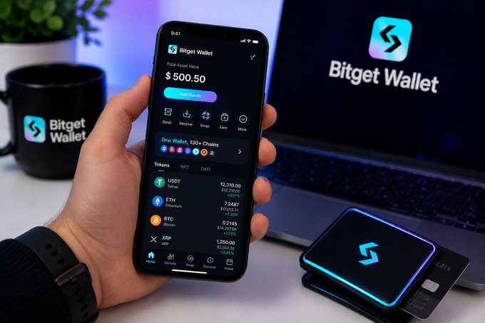 A hand holds a smartphone displaying the Bitget Wallet app, showing a total asset value of $500.50 and token holdings including USDT ($12,310.00), ETH ($7,268.71), BTC ($0.2145), and XRP ($1,250.00), alongside a branded mug and a hardware wallet device. The image visually reinforces the post's highlighting of Bitget Wallet's practical features by showcasing its clean interface for managing multiple crypto assets and cross-chain tokens.