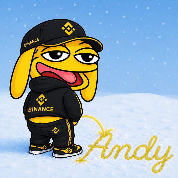 A cartoon illustration of a yellow dog mascot wearing a black cap and hoodie with the Binance logo, writing the word 'Andy' in yellow in the snow.