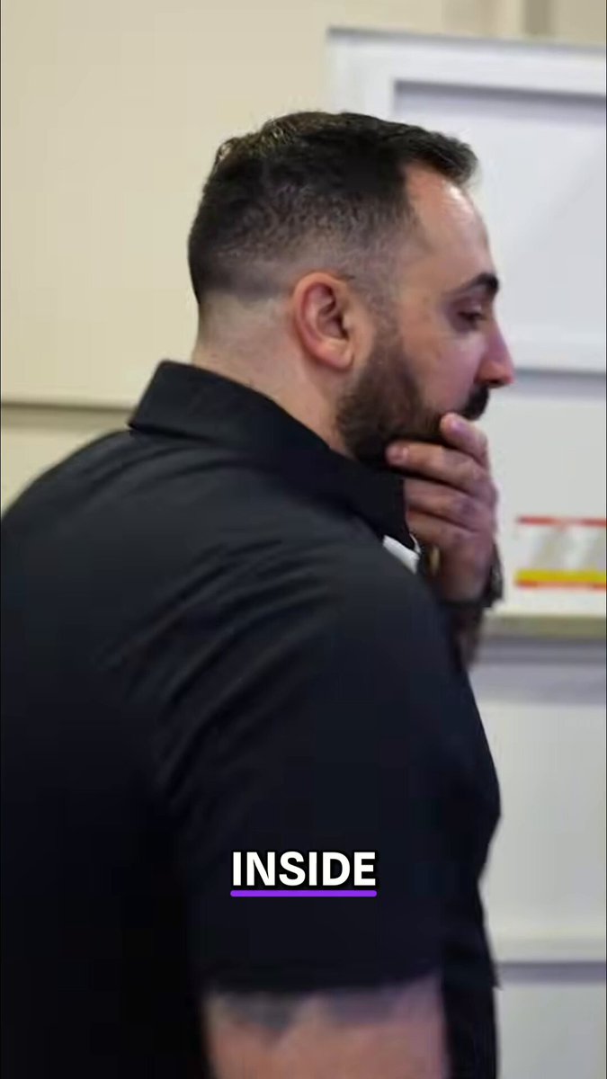 The image shows a man wearing a black shirt, standing against a wall with his hand placed over his mouth as if deep in thought or contemplation. The background features a white door that appears to be part of a building's interior design. There is also an image of a mining container on the wall, which seems to be related to the post about mining operations and infrastructure.