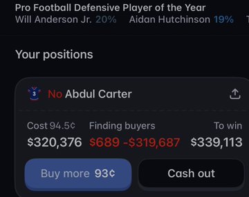 A mobile app screenshot showing a sports prediction market for 'Pro Football Defensive Player of the Year' with options for Will Anderson Jr. and Aidan Hutchinson, and a user position on 'Abdul Carter' showing a cost of $320,376 and potential winnings of $339,113.