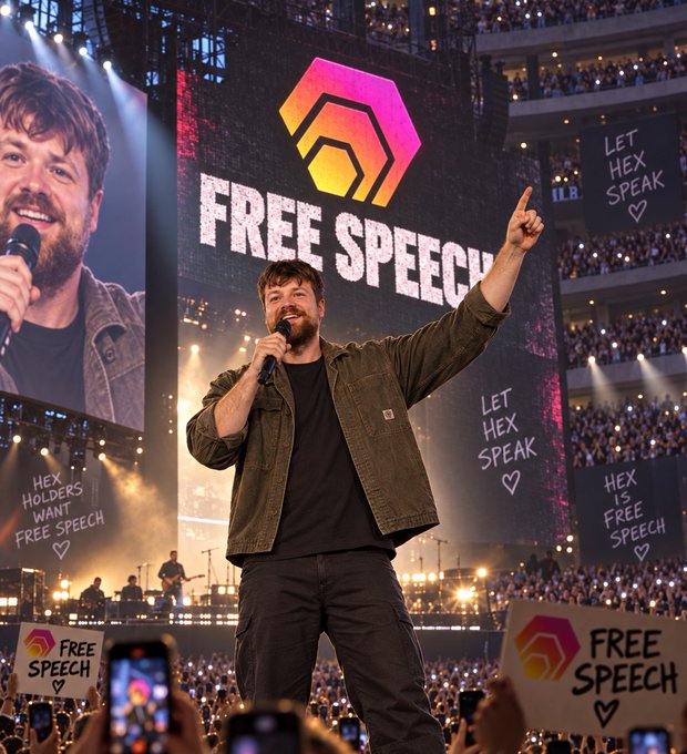 An AI-generated or stylized image of a man speaking at a rally holding a microphone, with large screens behind him displaying the Hex (HEX) logo and the slogan 'FREE SPEECH,' while the crowd holds 'HEX is FREE SPEECH' signs.