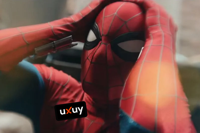 Spider-Man clutches his head in apparent frustration or disbelief, matching the meme's expression of shock or exasperation, with the "uxuy" logo visible in the corner suggesting the frustrated reaction is toward that trading platform.