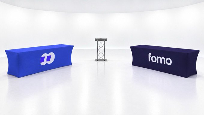 A crypto creator is looking to collaborate with two more creators on a video project, with the image showing two branded tables labeled "fomo" set up in a studio for the filming.