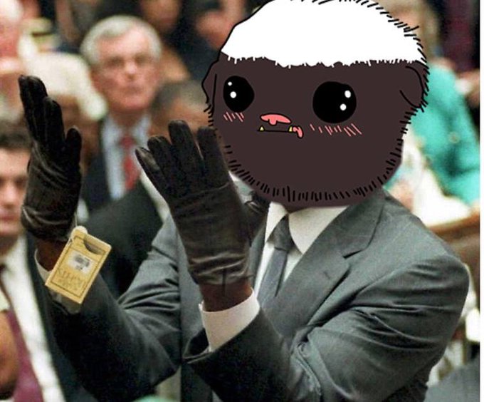 A man in a gray suit and black gloves applauds at a formal event, his face humorously replaced with a cute cartoonish brown creature with big eyes and a white-frosted head, while a press badge reading "OPEN ONLY" is clipped to his sleeve—pairing with the "Oj Vej, I need more $hoba" caption to suggest a Nordic/Slavic plea for more money (currency colloquially called "shoba" in meme-speak).