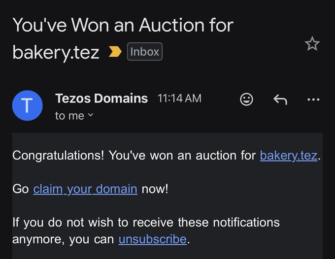 The image shows a message from Tezos Domains auction site congratulating someone for winning an auction. The text reads "Congratulations! You've won an auction for bakery.tez". This person has won an auction for a domain name, which is now theirs to claim.