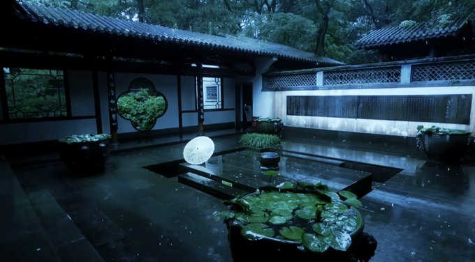 A serene traditional Chinese courtyard with a wet stone floor, a small pond, a white parasol, and a decorative circular window framing lush greenery. The image pairs with the "happy new month" crypto tweet as a calm, contemplative contrast to the energetic market chatter.