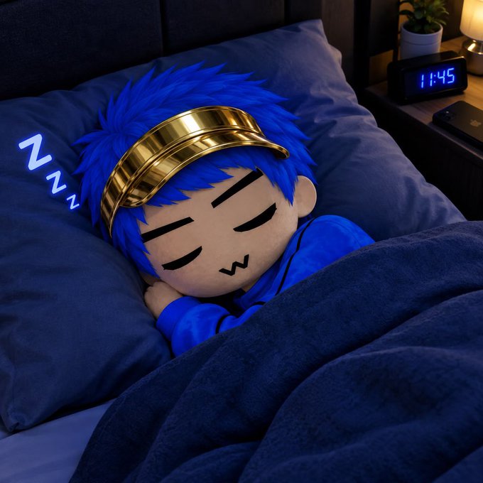 A blue-haired plush toy with a golden headband sleeping in a bed with dark blue bedding, with a digital clock reading '11:45' and 'Zzz' floating nearby.