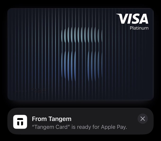 The image shows an advertisement for a credit card company called "Tangem" that allows users to add cryptocurrency to their payment experience. The text on the screen reads, "From Tangem Card", indicating that the user has already added the credit card to their account. The post also mentions that the credit card is ready for use and can be used at any time with a simple tap or scan.