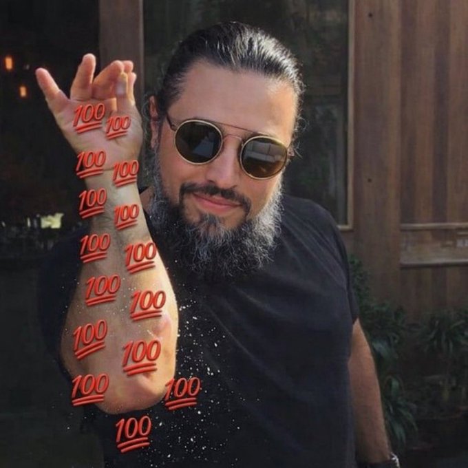 A bearded man wearing sunglasses smiles while holding up his arm, which is digitally covered in red "100" emojis stacked along his forearm and hand. The flood of "100" symbols visually reinforces the post's message of crypto enthusiasm and bullish acknowledgment, matching the "GM" (good morning) greeting and tags to crypto community members like @marexverse and @bull_and_bean.