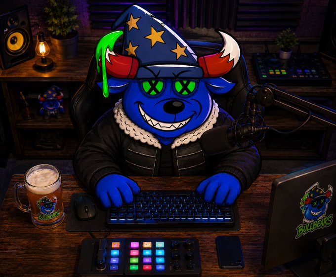 An animated illustration of a blue cartoon character wearing a wizard hat with stars and green 'X' eyes, sitting at a desk with a keyboard, microphone, and a laptop displaying 'BILLBEARS'.