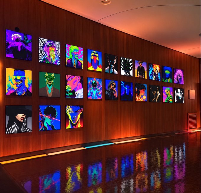 A gallery wall displays a grid of vibrant, colorful pop-art style portrait paintings, their neon hues reflecting on the polished floor below.