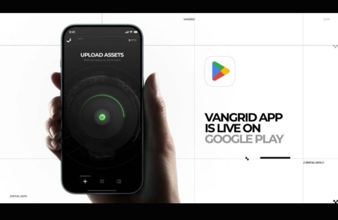 A hand holding a smartphone displaying an 'UPLOAD ASSETS' screen with a green radar-like graphic, alongside promotional text reading 'VANGRID APP IS LIVE ON GOOGLE PLAY'.