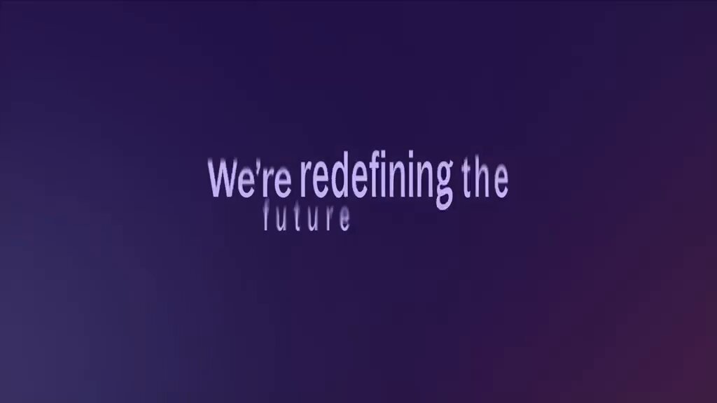 The image features a purple banner with white text that reads "We're redefining the future". The text is written in a cursive font style, giving it an artistic touch. The background of the image is dark blue, which contrasts nicely with the purple banner and makes the text stand out even more.