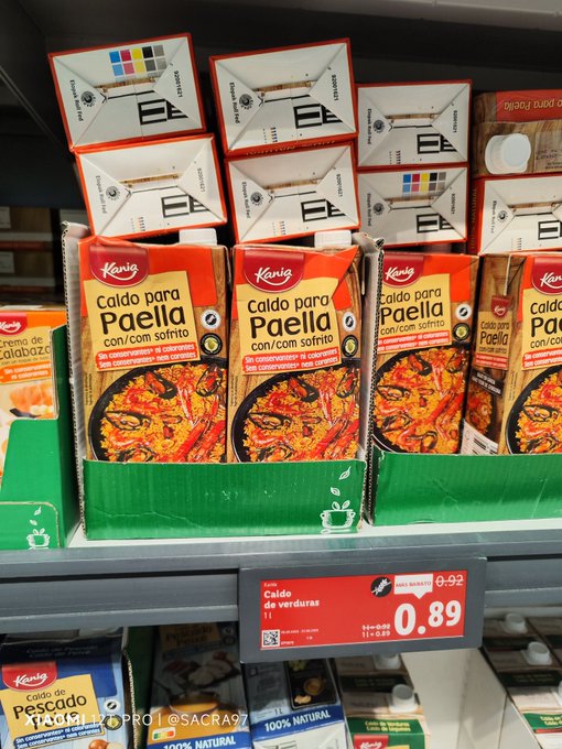 The image shows a shelf with various cartons of food items, including milk and juice boxes. There are at least six cartons visible, each containing different types of food or drinks. The cartons are stacked on top of one another, creating an organized display for customers to easily identify the products available. The post in the image is about honey, which could be a related product to some of the items displayed on the shelf.