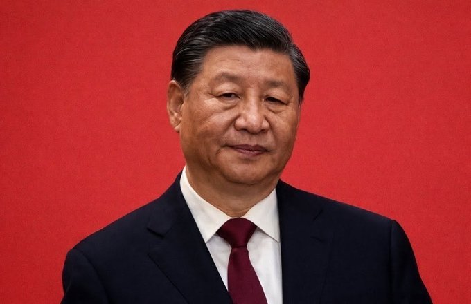 A portrait of Xi Jinping, the President of China, against a red background, likely symbolizing governmental decisions on gold transactions. As the leader of China, his image is relevant to the news of major banks, including ICBC, banning paper gold.