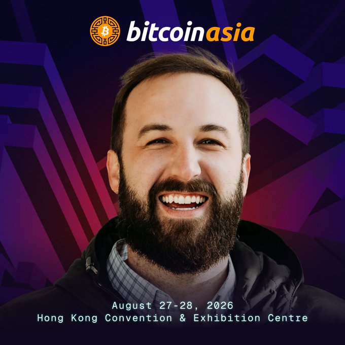 The image features a man with a beard wearing a black jacket smiling for the camera. The background of the photo has purple and blue colors, which are typical elements found at Bitcoin Asia events. The text "Bitcoin is reshaping institutions from within as more insiders adopt it" suggests that the event is focused on promoting Bitcoin's impact on traditional financial systems. The post also mentions a Hong Kong Convention & Exhibition Centre, indicating that this event might be taking place in Hong Kong or has ties to the region.