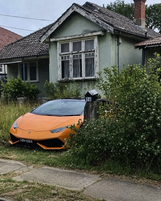 An orange Lamborghini with the license plate "ZH-1023" sits parked in the overgrown yard of a dilapidated, weathered green house, symbolizing the ultimate "rags to riches" crypto dream. The caption "the next bull run gonna be crazy" humorously suggests that this ordinary homeowner's modest life is about to be transformed by imminent crypto wealth, with the exotic supercar serving as a visual metaphor for the financial windfall they're anticipating.
