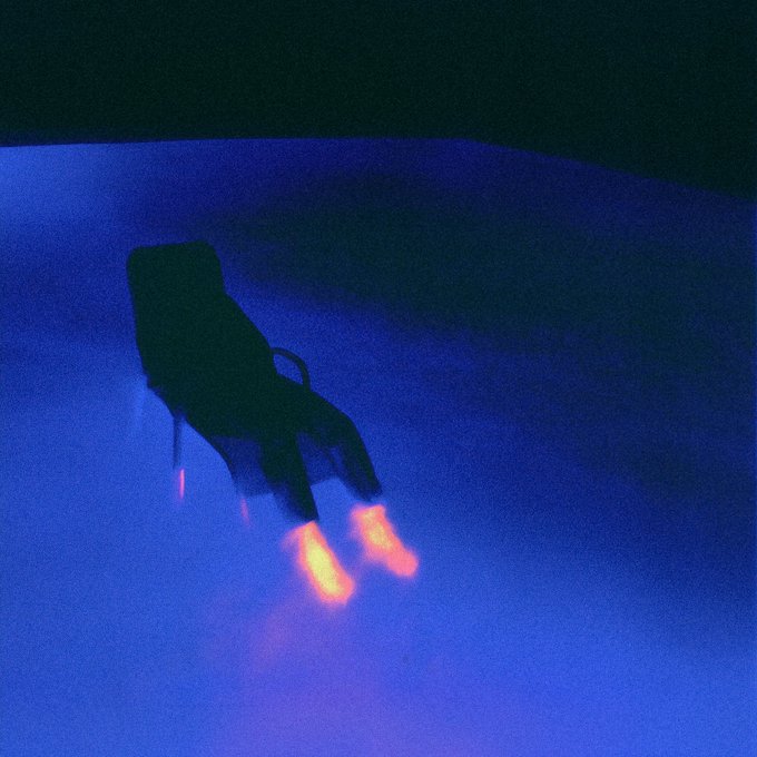The image features an empty chair sitting in front of a blue background. The chair appears to be glowing with a warm light, creating a striking contrast against the cool tones of the scene. The photo has been edited to give it a purple tint, adding depth and visual interest to the composition. The caption reads "GM! Feeling energized and ready for a new week" which is related to the image in some way but does not directly connect with the chair or its glowing appearance.
