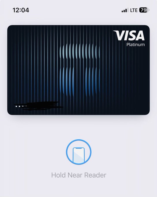 A Visa Platinum card is displayed in the Tangem app interface with a "Hold Near Reader" prompt, indicating the user is showcasing a Tangem hardware crypto wallet that features the Visa Platinum card design for making contactless payments.