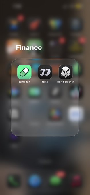An iOS home screen folder labeled "Finance" containing three apps: pump.fun, Fomo, and DEX Screener, with the rest of the apps blurred in the background.