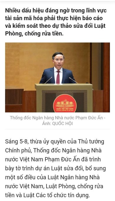 A Vietnamese news article featuring a photo of a man in a suit speaking at a podium with the National Assembly emblem, captioned as 'Thống đốc Ngân hàng Nhà nước Phạm Đức Ấn - Ảnh: QUỐC HỘI', discussing draft laws on anti-money laundering.