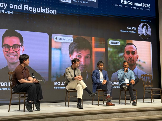 A moderator interviews panelists Mo Jalid (EthSystems), and Adam (Axelar) - along with a third panelist (pictured on the screen) - at the "The Direction of Institutional Privacy" panel during EthConnect 2026 at Hotel Kita in Seoul, Korea.