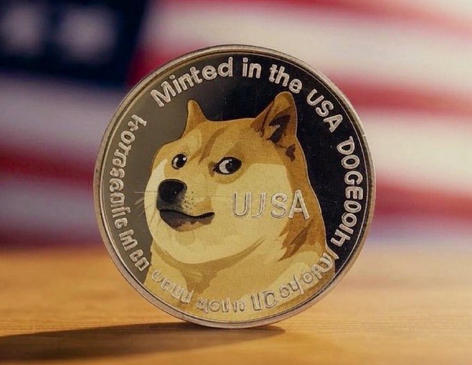The image features a silver coin with a cartoon depiction of a dog's face, which appears to be minted in the USA. The coin has a value of one dollar and is sitting on top of a wooden surface. The text "DOGECOIN" can be seen next to the coin, indicating that it is a commemorative coin dedicated to the beloved pet dog.