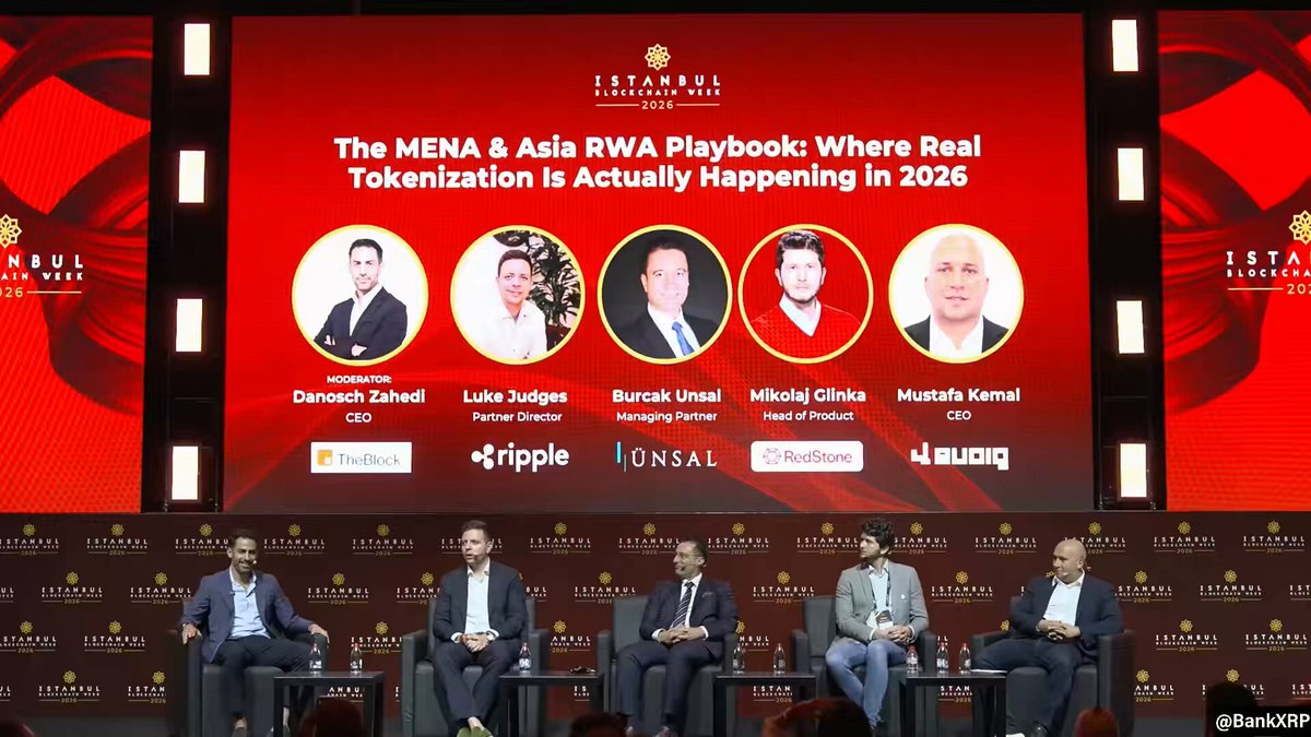 The image shows a group of five men seated around each other on several chairs positioned behind a stage with a large screen displaying an event title "The Mena & RWA Ecosystem Just Crossed $3 Billion In tokenized RWAs In April." An accompanying text states that they've just crossed $3 Billion in RWAs, sharing insights about how this could be the start of something real. The backdrop features red lights and black silhouettes of men, which are relevant to the event's theme.