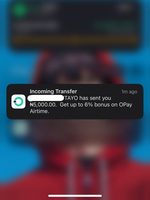 A mobile phone notification shows an 'Incoming Transfer' of '₦5,000.00' from 'TAYO' with the message 'Get up to 6% bonus on OPay Airtime' over a blurred background.
