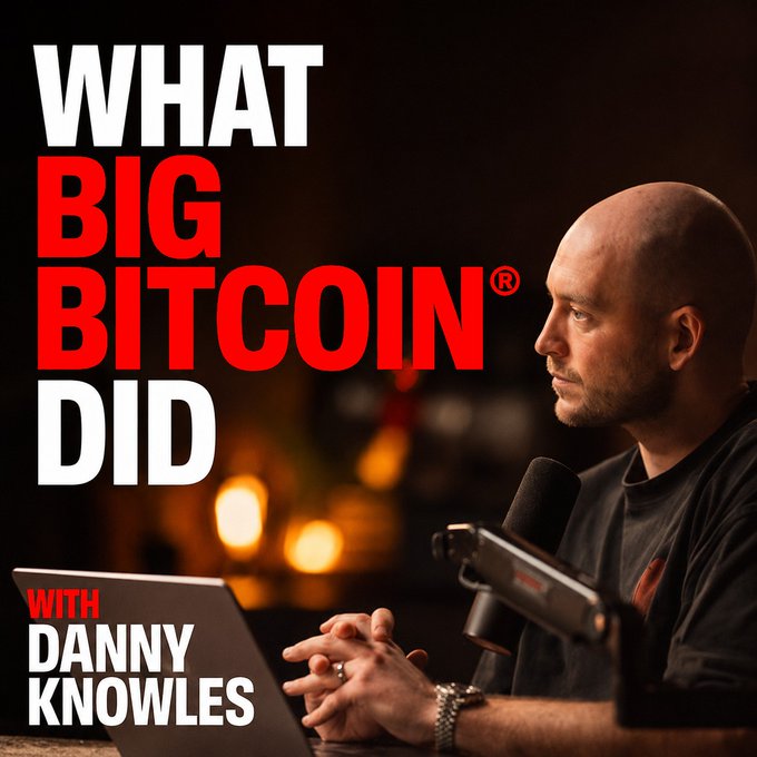 A podcast cover for 'WHAT BIG BITCOIN DID WITH DANNY KNOWLES,' showing a man with a shaved head sitting at a microphone and laptop in a dimly lit setting.