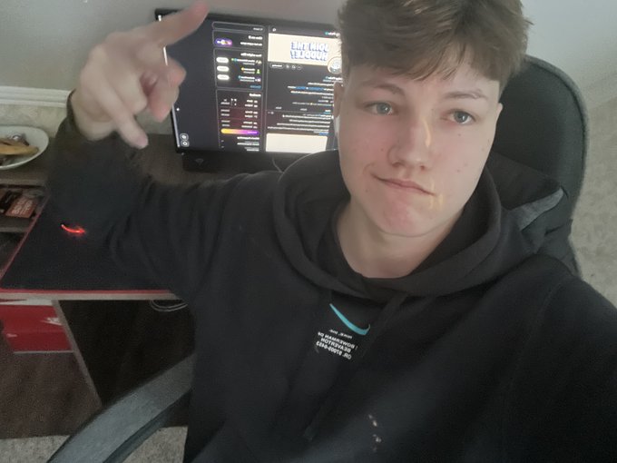 A young person in a black hoodie sits in front of a computer monitor displaying what appears to be a Discord interface, pointing toward the screen while announcing the new @PudgyPicks sub-community aimed at helping people find their perfect Pudgy Penguin NFT. The image conveys the creator's enthusiasm as they prepare to share beautiful Pudgy Penguin picks with the community.