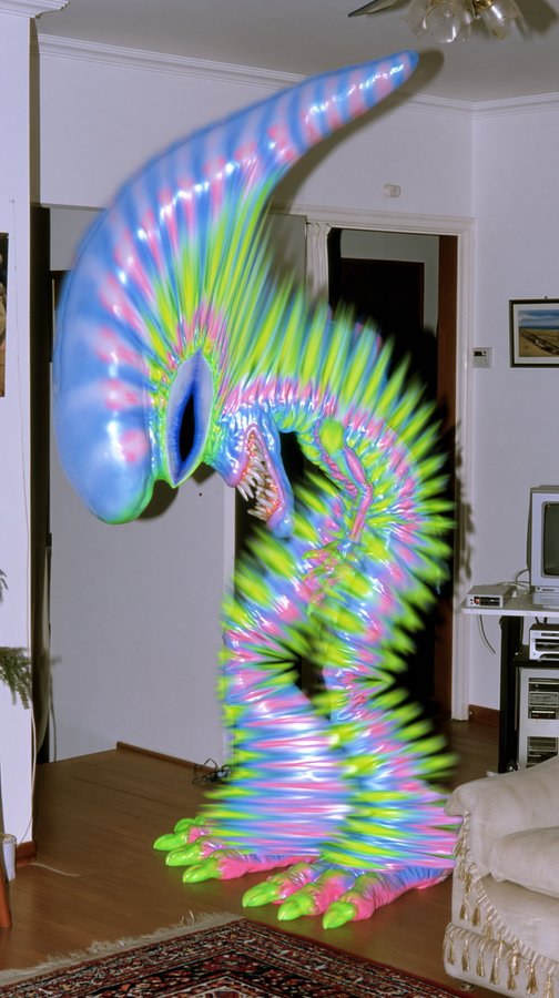 A surreal AI-generated image showing a large, colorful, elongated monster-like creature with iridescent blue, pink, and green coloring standing inside a domestic living room.