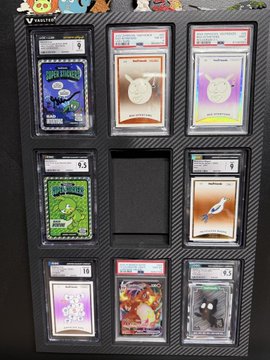 A black display binder page contains eight graded Pokémon cards in PSA slabs, including Blastoise and Charmander, with visible grades of 6.5, 8.5, and 10, and an empty slot in the middle right.