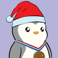 A small cartoon penguin wearing a red Santa hat and holding a medal against a purple background.