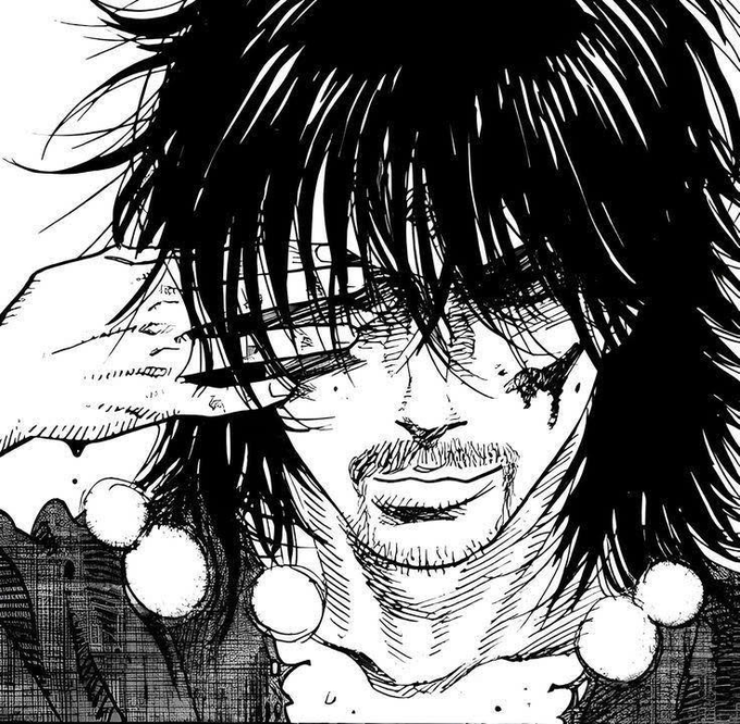 A black and white manga-style drawing of a person's face with messy hair covering their eyes, revealing a sinister smile and a beaded necklace.