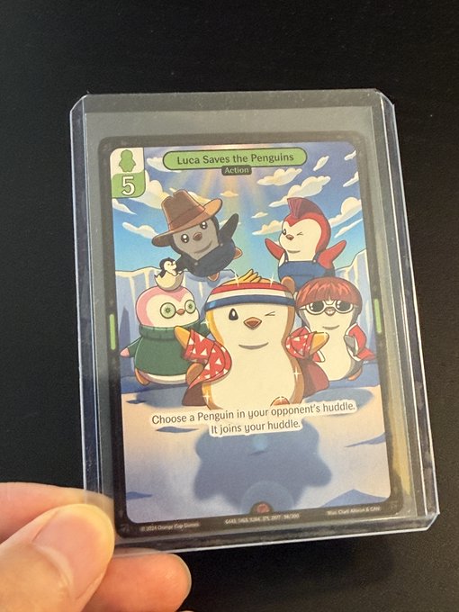 A hand holding a protective card sleeve containing a trading card titled 'Luca Saves the Penguins' (Action, level 5), featuring cartoon characters in winter clothing, with text 'Choose a Penguin in your opponent's huddle. It joins your huddle.'