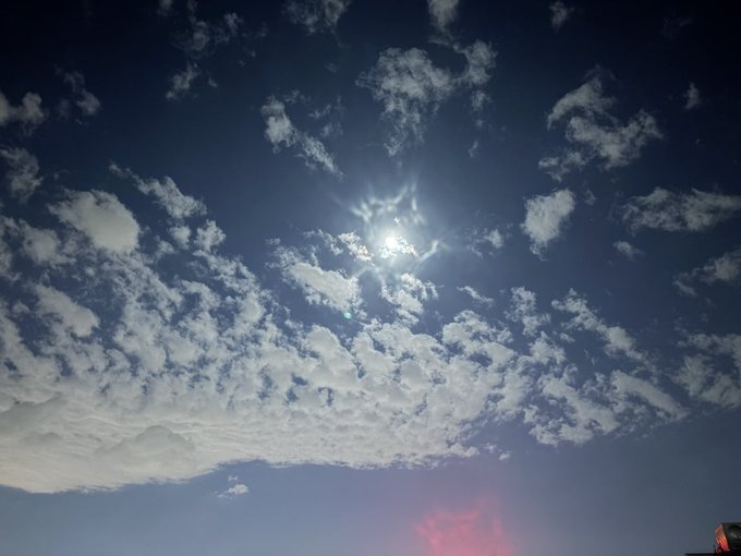 The sun shines brightly through scattered clouds in a deep blue sky, reflecting the lingering heat of an "autumn tiger" — an unusually warm late-season day that has made sleep impossible and pushed the poster to stay awake trading meme coins instead.