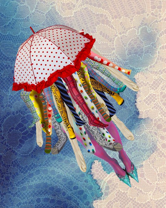 A colorful jellyfish art piece featuring a red polka-dot umbrella as the bell and various patterned fabric tentacles hanging below, set against a blue water-patterned background.