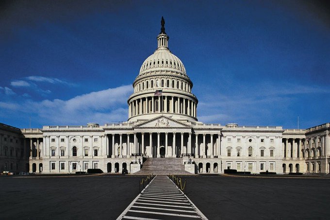 The image shows the United States Capitol Building, the seat of the U.S. Congress in Washington, D.C., featuring its iconic white dome and neoclassical façade under a deep blue sky. This visual directly relates to the upcoming U.S. Senate vote on the CLARITY Act on September 15, as the Capitol is where senators will convene to deliberate on the legislation.