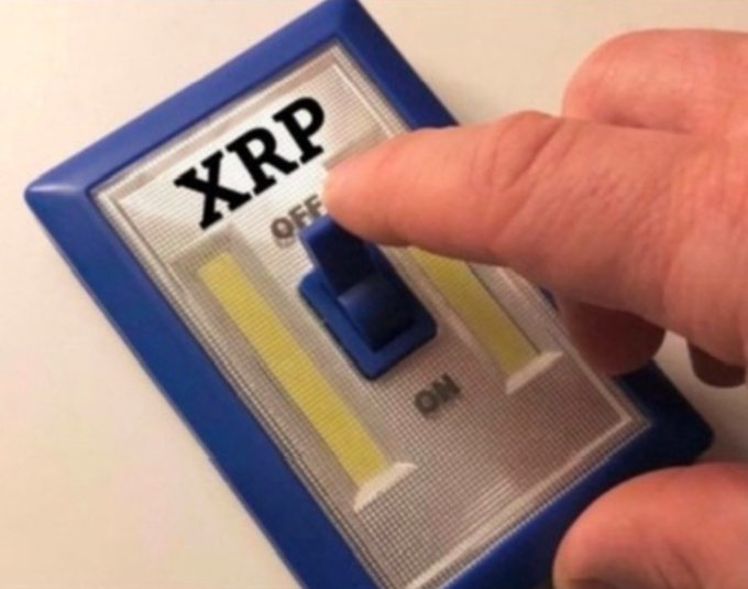 A finger flips a blue switch from "OFF" to "ON" on a panel labeled "XRP," symbolizing the anticipated ignition of Ripple's price rally toward triple digits and beyond.