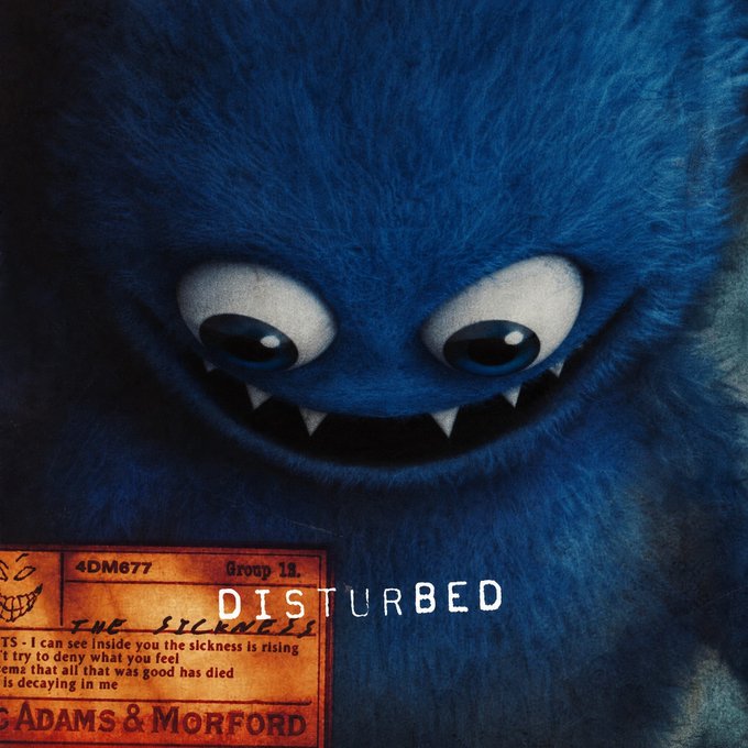 A textured, dark blue furry monster character with sharp teeth and large eyes, overlaid with text reading 'DISTURBED' and 'ADAMS & MORFORD' alongside a vintage-style ticket.