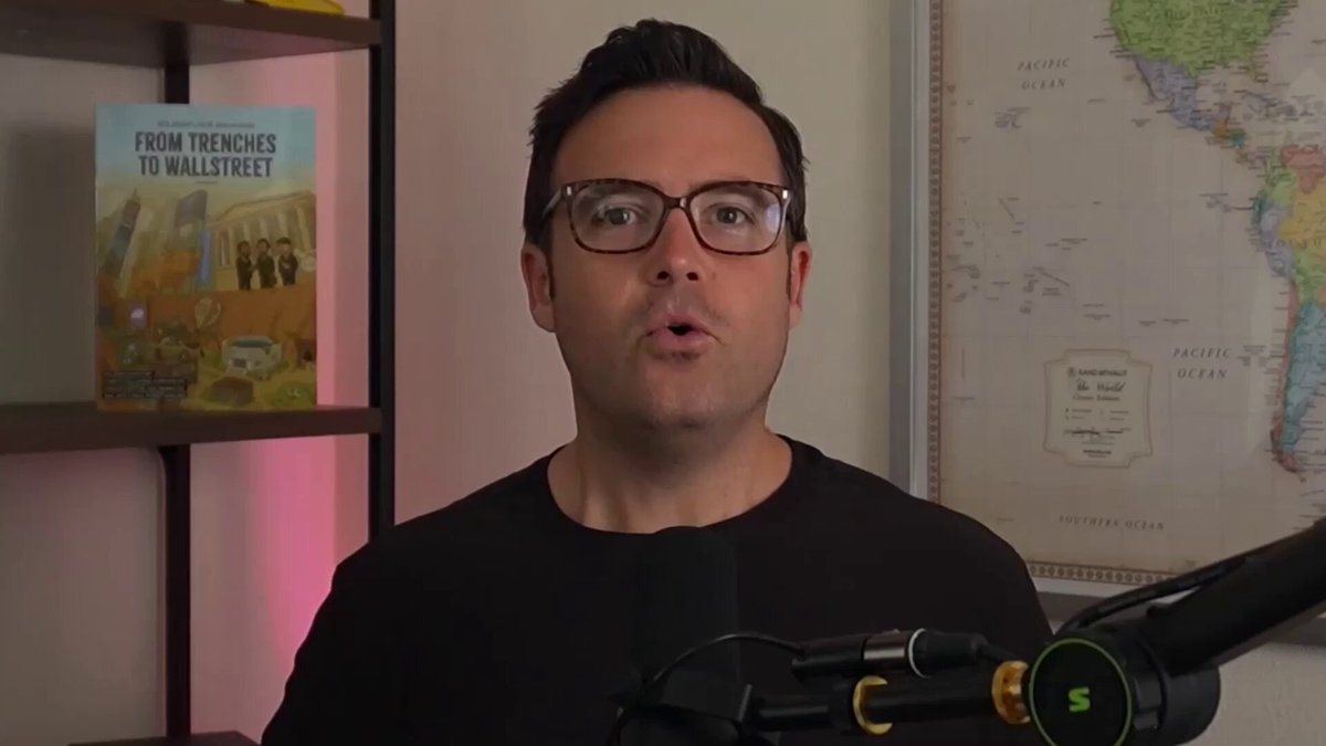 The image shows a man wearing glasses sitting at a microphone with his mouth open as if he's speaking into it, possibly giving a speech or interview. The background features a map of the world, which could be related to the topic of the post. The text in the image reads "From trenches to Wall Street", suggesting that the man might be discussing the history and evolution of financial institutions. Additionally, there is an image of a book titled "From Trenches to Wall Street" on the wall behind him, further reinforcing the connection between the man's speech and the content displayed in the image.