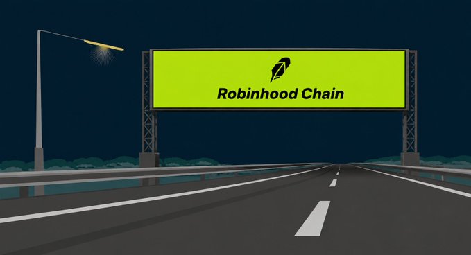 A glowing billboard along an empty highway reads "Robinhood Chain" with the platform's feather logo, symbolizing the launch of a new blockchain era. The image visually represents the "reboot" moment mentioned in the caption, as the illuminated sign suggests a fresh beginning and forward momentum for the crypto space following Robinhood's mainnet debut.