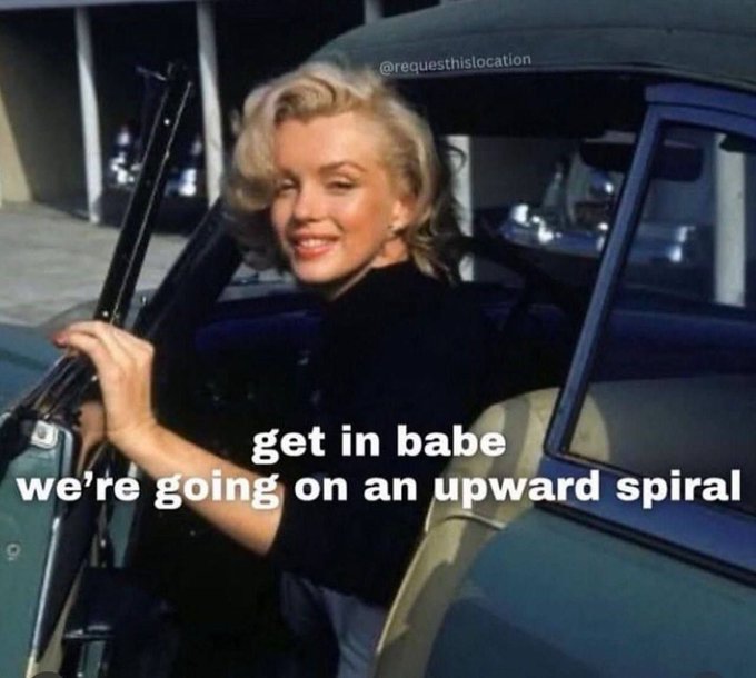 A vintage photo of Marilyn Monroe by a car door with overlaid text reading 'get in babe we're going on an upward spiral' and a watermark '@requestthislocation'.